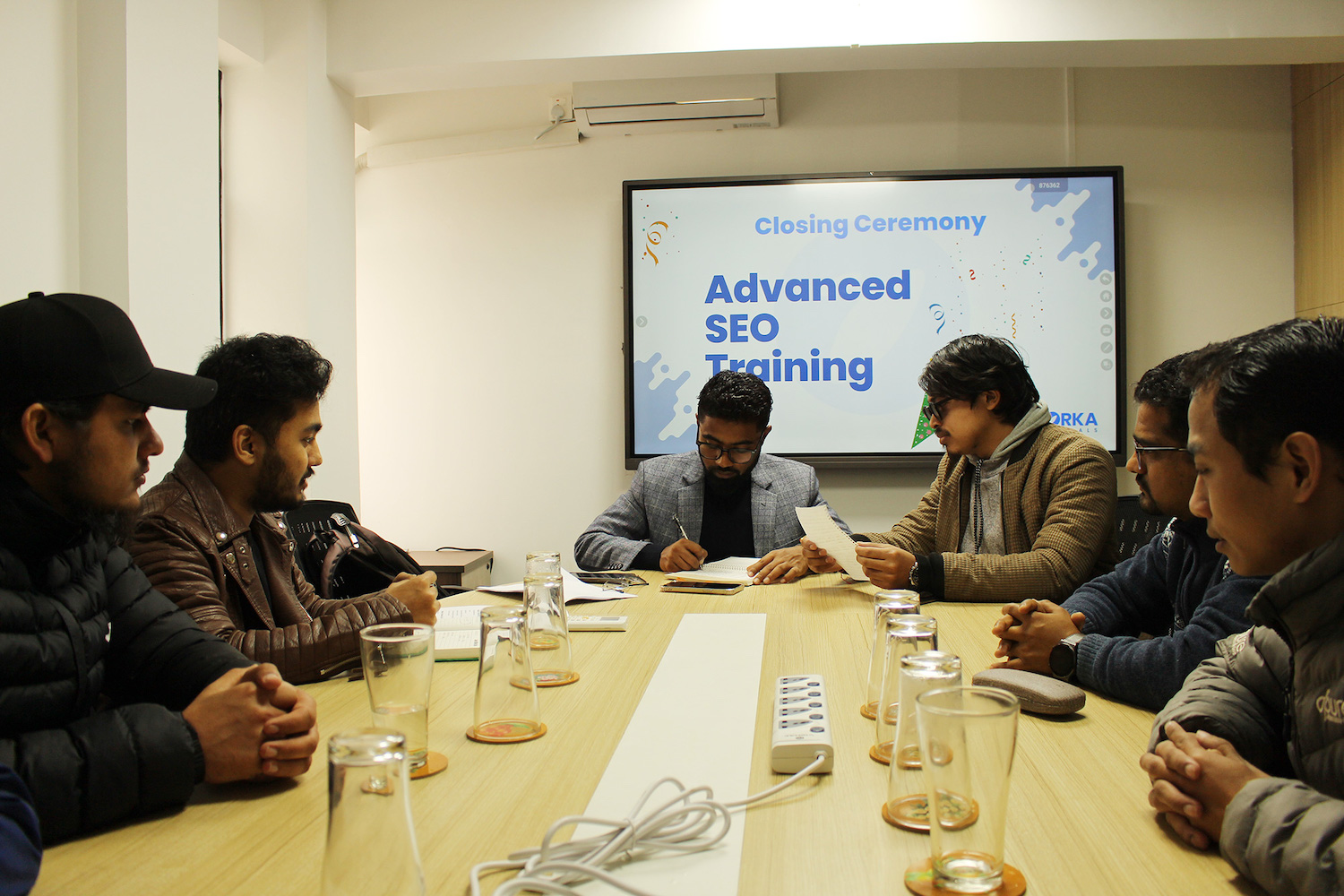 Rambabu Thapa working with beginner SEO students during a feedback session at the Orka Socials Lalitpur office.