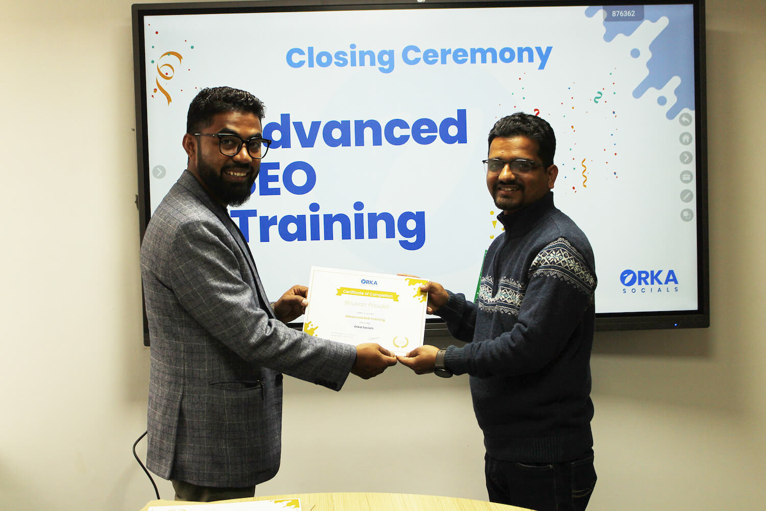 Bhuvan Paudel receiving his Orka Socials SEO Mastery Course certificate from Rambabu Thapa.