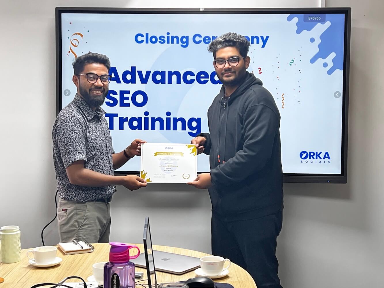 Rambabu Thapa handing SEO Training certificate to Mukesh Lekhak.