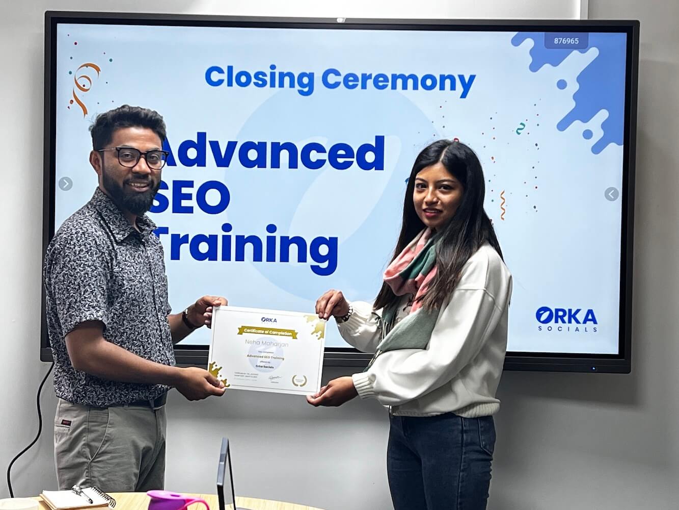Rambabu Thapa handing SEO Mastery Course certificate to Neha Maharjan.